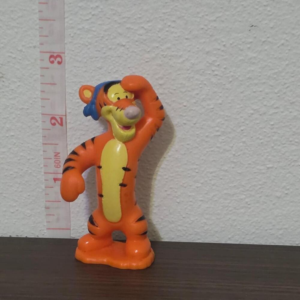 Disney Tigger figurine with orange body, black stripes, and yellow belly #disney